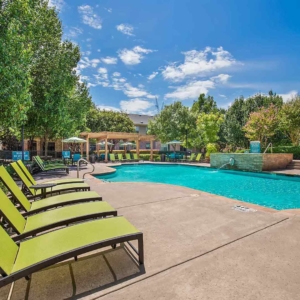 Pool with fountain and brightly colored pool furniture