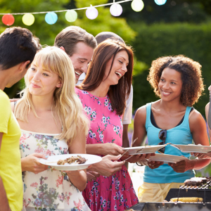 friends laughing and enjoying grilling out together