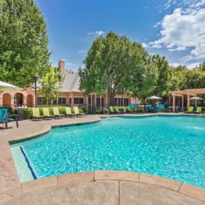 Pool at Villas with Patio furniture wooden arbors and bright blue skies