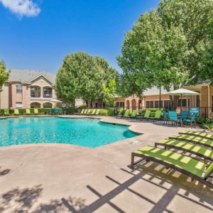 Pool with row of brightly colored lounge chairs