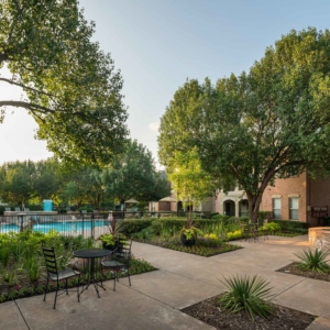 Peaceful tree lined courtyard outside the pool at Villas