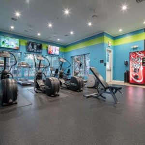 Fitness center at Villas of Spring Creek with eliptical machines in the foreground
