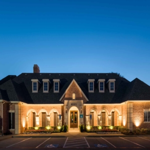 Nighttime view of the clubhouse exterior facade at villas